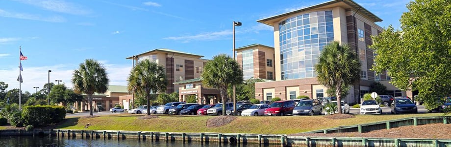 Tidelands building from distance on bright blue sky day