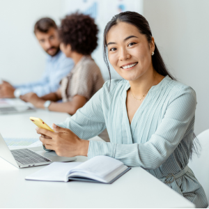 business-woman-smiling-with-phone-in-hand